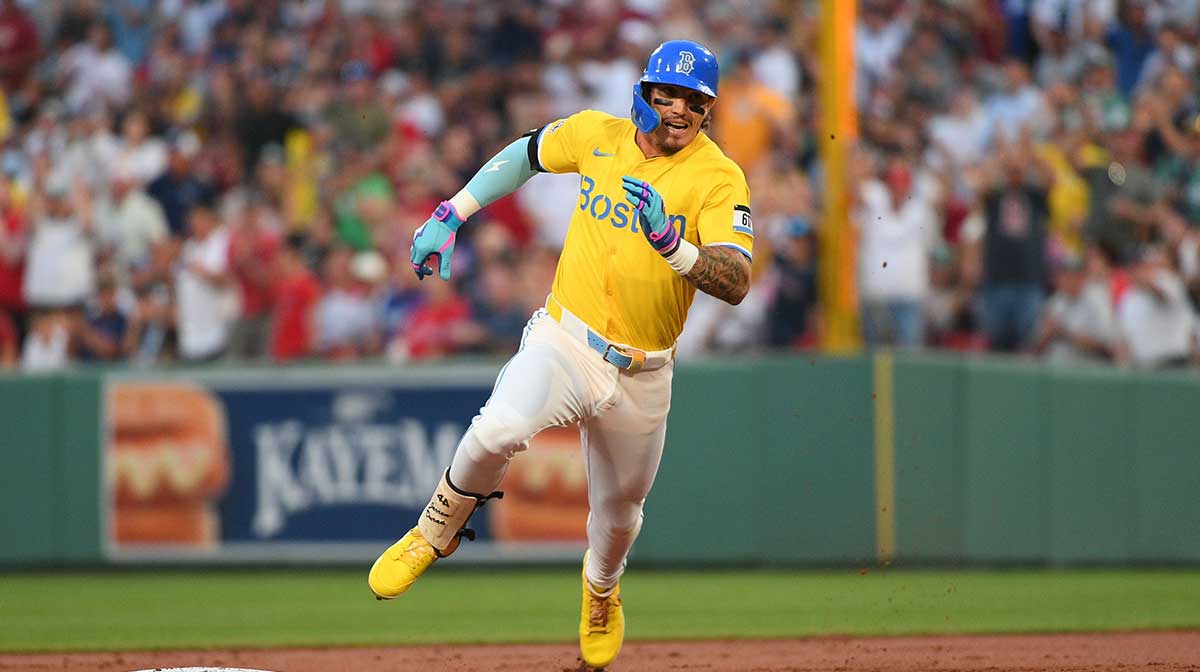 Boston Red Sox left fielder Jarren Duran (16) runs to third for a triple during the second inning against the Los Angeles Dodgers at Fenway Park.