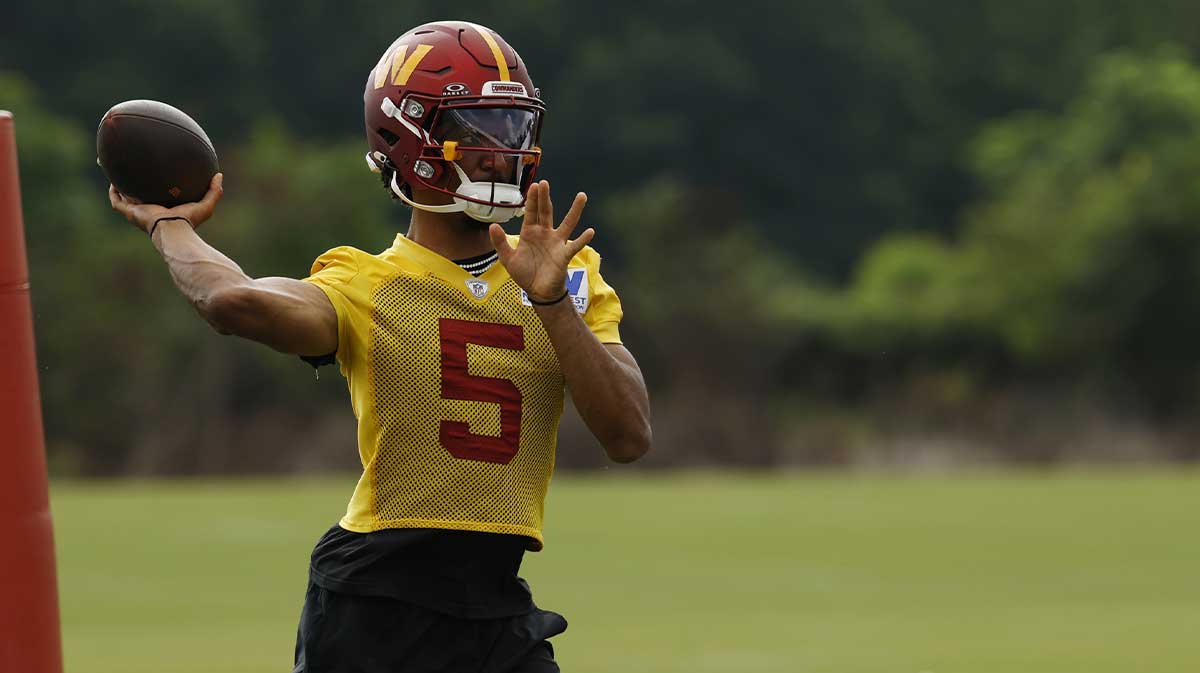 Washington Commanders quarterback Jayden Daniels (5) passes a ball during practice on day one of training camp at OrthoVirginia Training Center at Commanders Park.