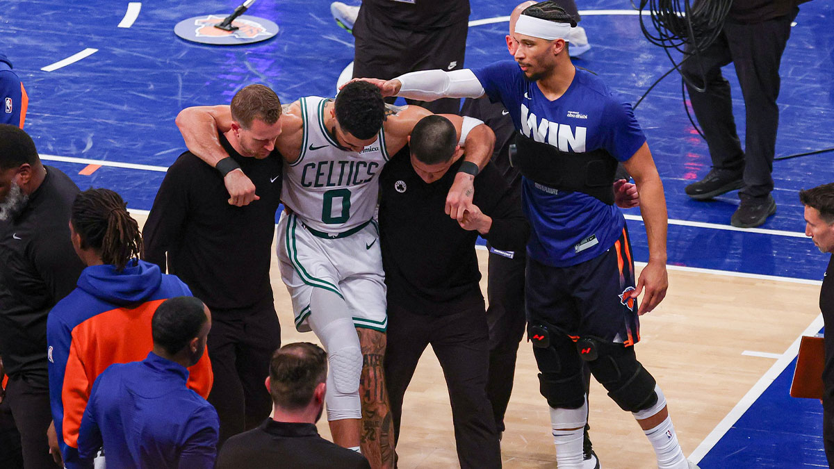 Boston Celtics forward Jayson Tatum (0) is helped off the court by after an injury in the second half during game four of the second round for the 2025 NBA Playoffs as New York Knicks guard Josh Hart (3) gestures at Madison Square Garden. Tatum would leave the game with an injury after this play.