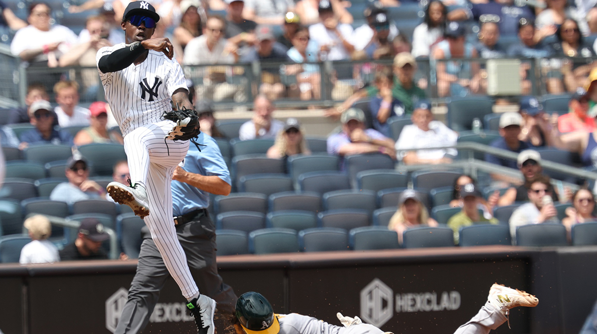 New York Yankees second base Jazz Chisholm Jr. (13) forces out Athletics catcher Willie MacIver (65) at third base and throws to first to complete the double play on a ball hit by shortstop Jacob Wilson (5) (not pictured) at Yankee Stadium. Mandatory Credit: Vincent Carchietta-Imagn Images