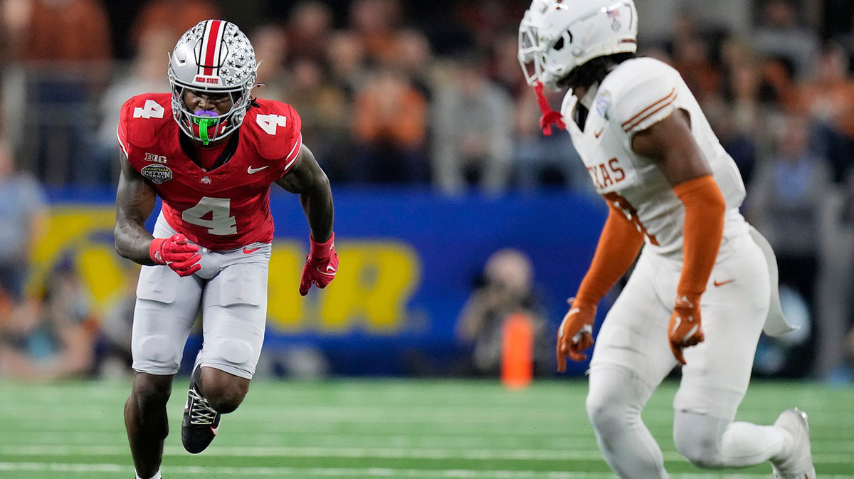 Ohio State Buckeyes wide receiver Jeremiah Smith (4) tries to get open against Texas Longhorns defensive back Jahdae Barron (7) in the fourth quarter of the Cotton Bowl Classic during the College Football Playoff semifinal game at AT&T Stadium in Arlington, Texas on January, 10, 2025.