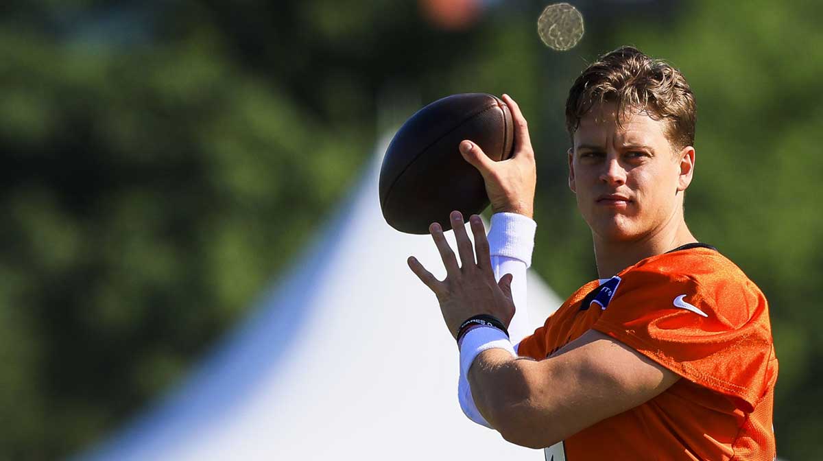 Cincinnati Bengals quarterback Joe Burrow (9) throws a pass during training camp at Kettering Health Practice Field.
