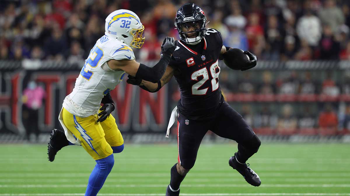 Houston Texans running back Joe Mixon (28) runs the ball against Los Angeles Chargers safety Alohi Gilman (32) during the third quarter in an AFC wild card game at NRG Stadium.