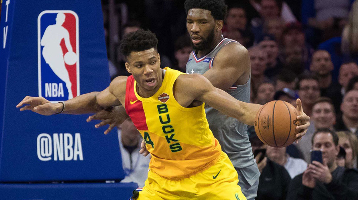 Milwaukee Bucks forward Giannis Antetokounmpo (34) handles the ball against Philadelphia 76ers center Joel Embiid (21) during the second quarter at Wells Fargo Center.