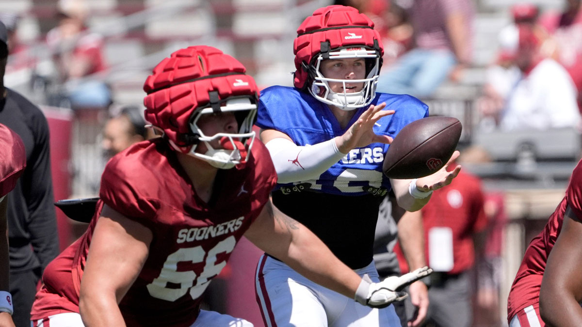 Oklahoma's John Mateer catches a snap as Derek Simmons blocks during the University of Oklahoma Sooners Crimson Combine at Gaylord Family - Oklahoma Memorial Stadium in Norman, Okla., Saturday, April, 12, 2025.