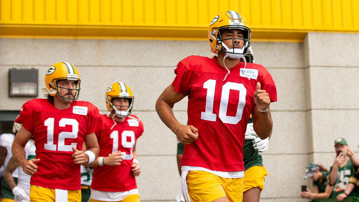 Green Bay Packers quarterback Jordan Love (10), Aaron Rodgers (12), and Danny Etling (19) run to the practice field during training camp on Monday, Aug. 1, 2022, at Ray Nitschke Field in Ashwaubenon, Wisconsin.