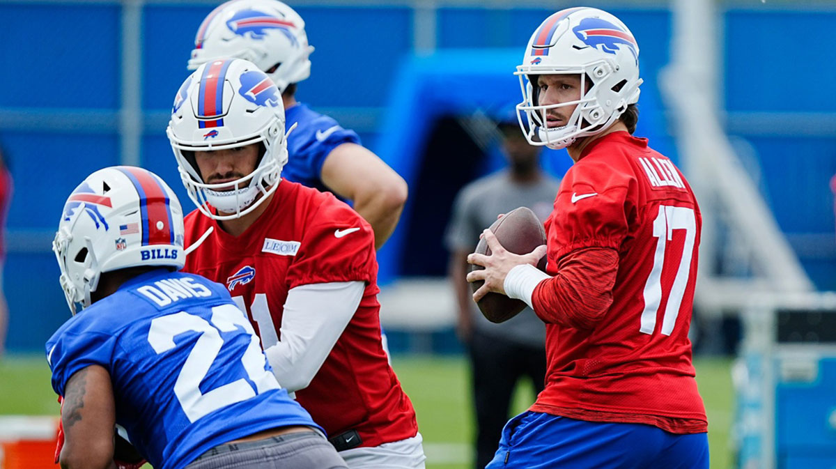 Buffalo Bills quarterback Josh Allen gets ready to throw to a receiver while back up quarterback Mitchell Trubisky hands off the ball to Ray Davis during their voluntary workout at their practice facility on May 27, 2025.