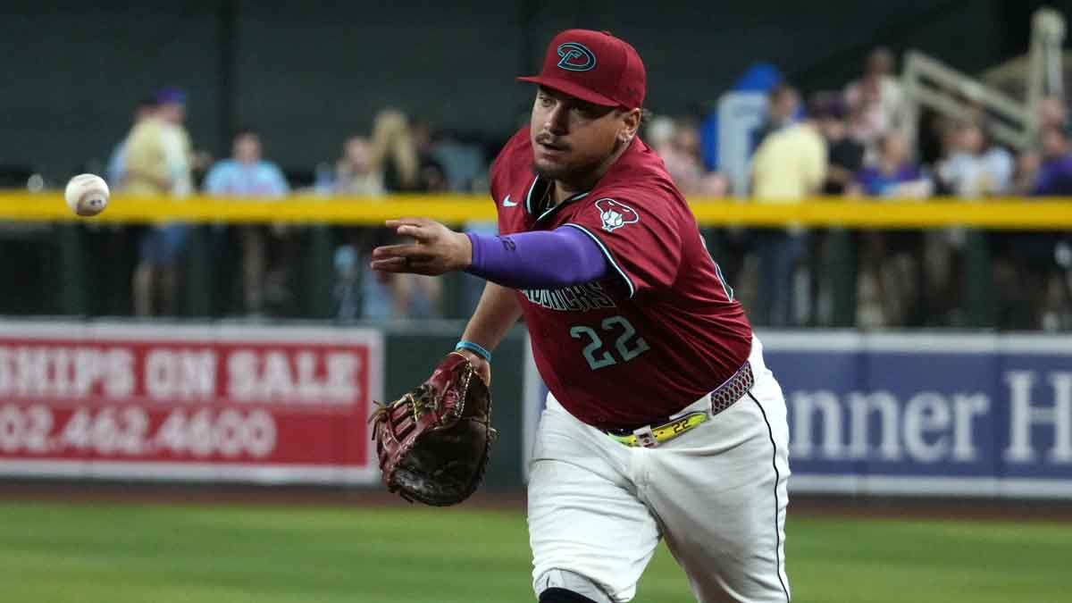 Arizona Diamondbacks first base Josh Naylor (22) flips the ball for an out against the Houston Astros in the fifth inning at Chase Field.