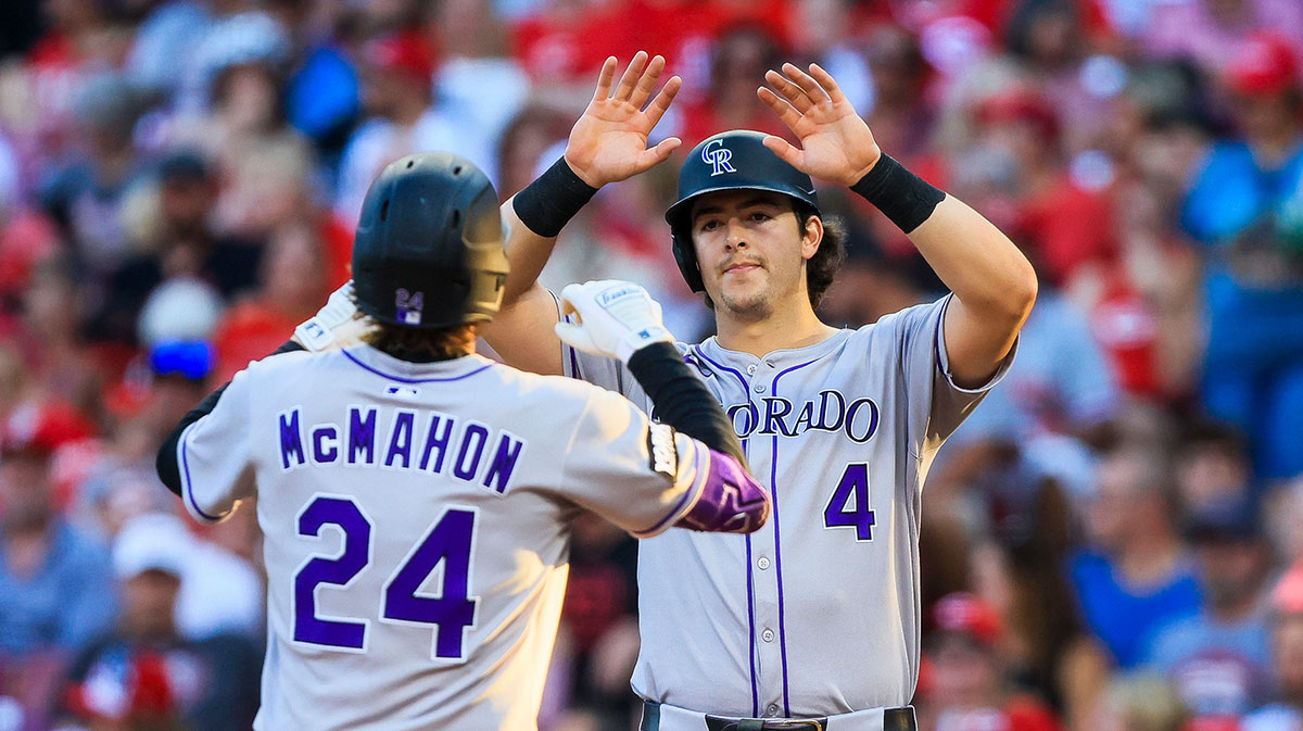 Colorado Rockies third baseman Ryan McMahon (24) high fives first baseman Michael Toglia (4) after hitting a two-run home run in the fourth inning against the Cincinnati Reds at Great American Ball Park. Mandatory Credit: Katie Stratman-Imagn Images