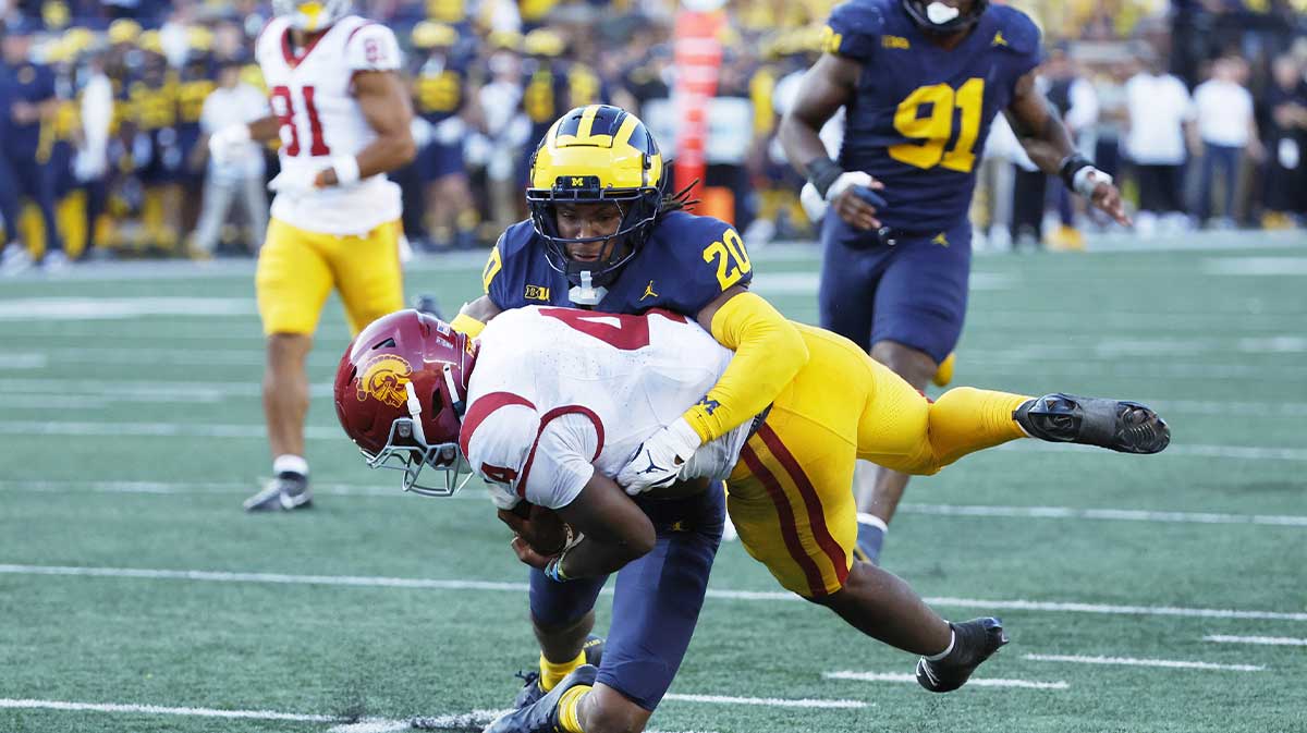 USC Trojans running back Woody Marks (4) is tackled by Michigan Wolverines defensive back Jyaire Hill (20) in the second half at Michigan Stadium.