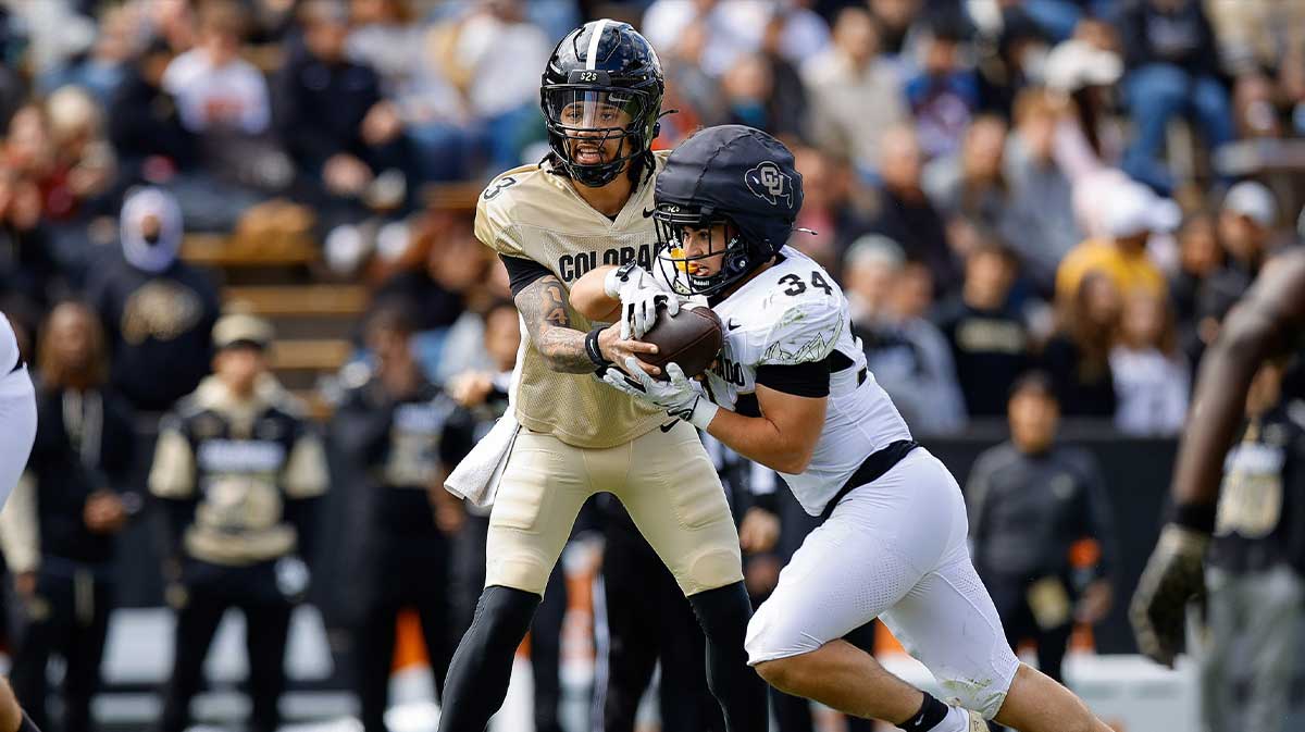 Colorado Buffaloes quarterback Kaidon Salter (3) hands the ball off to running back Titus Bautista (34) during the spring game at Folsom Field.