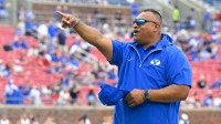 Brigham Young Cougars head coach Kalani Sitake waves to the fans before the game between the Southern Methodist Mustangs and the Brigham Young Cougars at Gerald J. Ford Stadium.