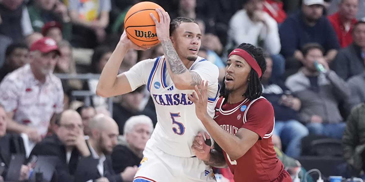 Kansas Jayhawks guard Zeke Mayo (5) controls the ball against Arkansas Razorbacks guard Boogie Fland (2) during the second half at Amica Mutual Pavilion.
