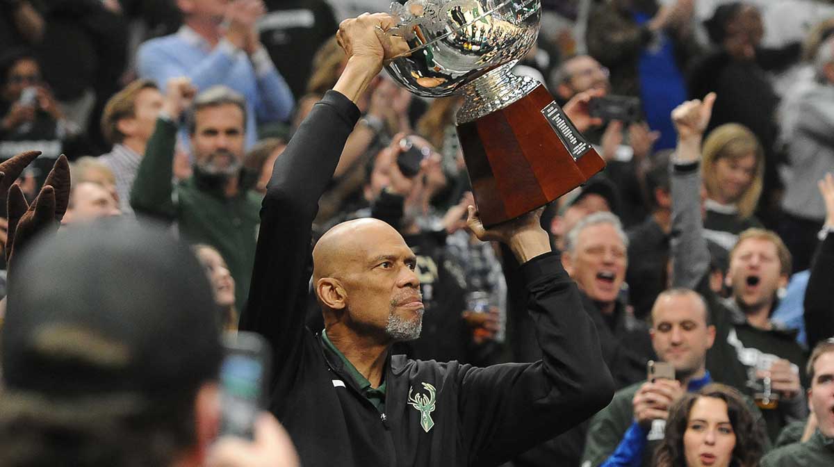 Milwaukee Bucks former player Kareem Abdul Jabbar holds up the 1971 championship trophy during a break in a game against the Detroit Pisotns during game one of the first round of the 2019 NBA Playoffs at Fiserv Forum.