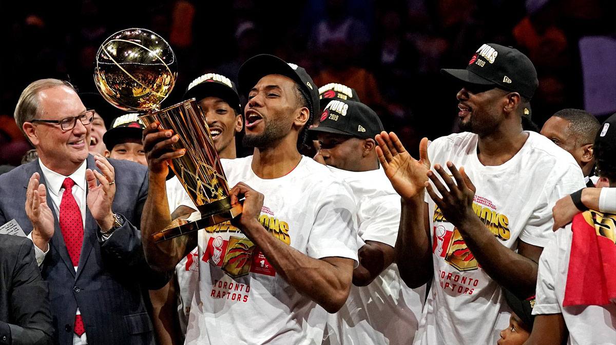 Toronto Raptors forward Kawhi Leonard (2) celebrates with the Larry O'Brien Trophy after the Golden State Warriors in game six of the 2019 NBA Finals at Oracle Arena.