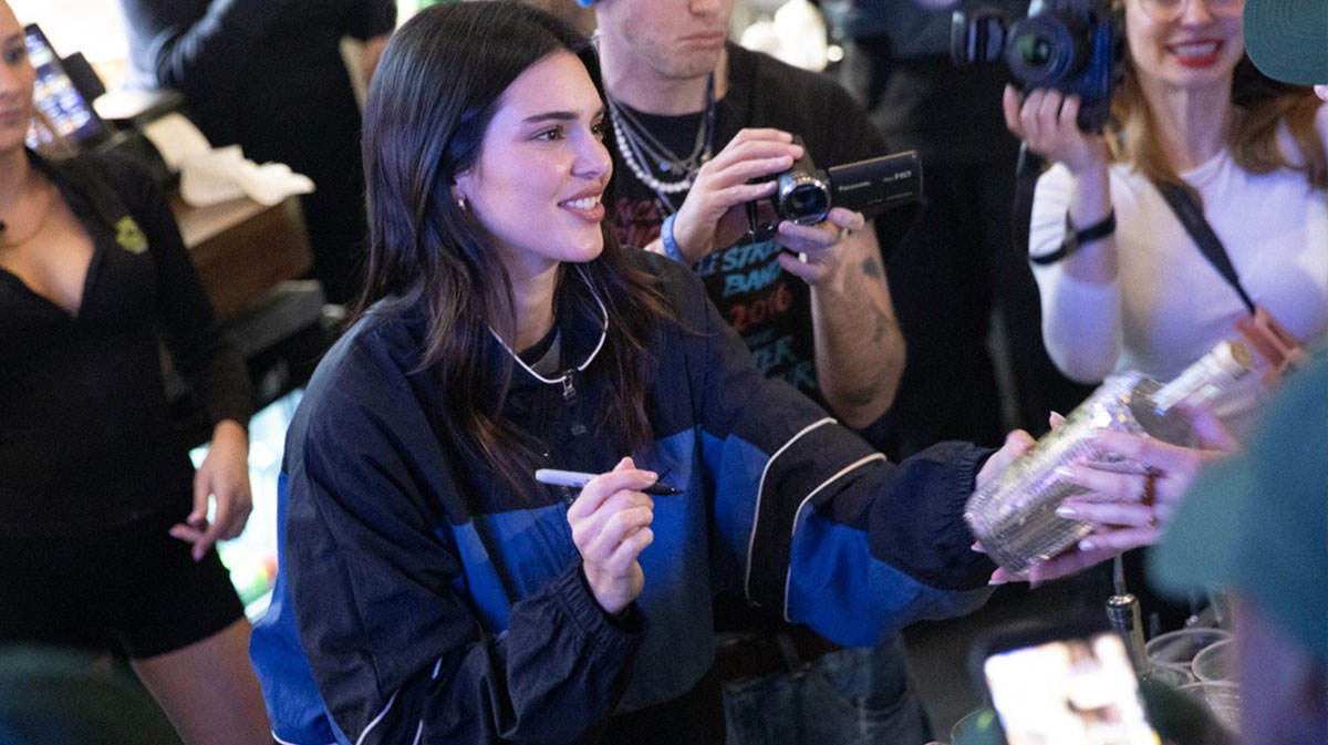 Kendall Jenner signs a bottle at The Swamp Restaurant on Wednesday in Gainesville.