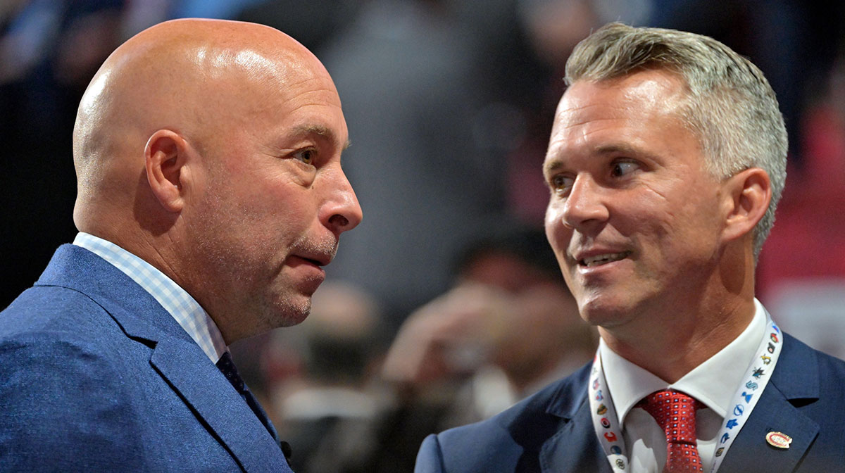 Montreal Canadiens general manager Kent Hughes (left) talks with head coach Martin St. Louis before the first round of the 2022 NHL Draft at Bell Centre.