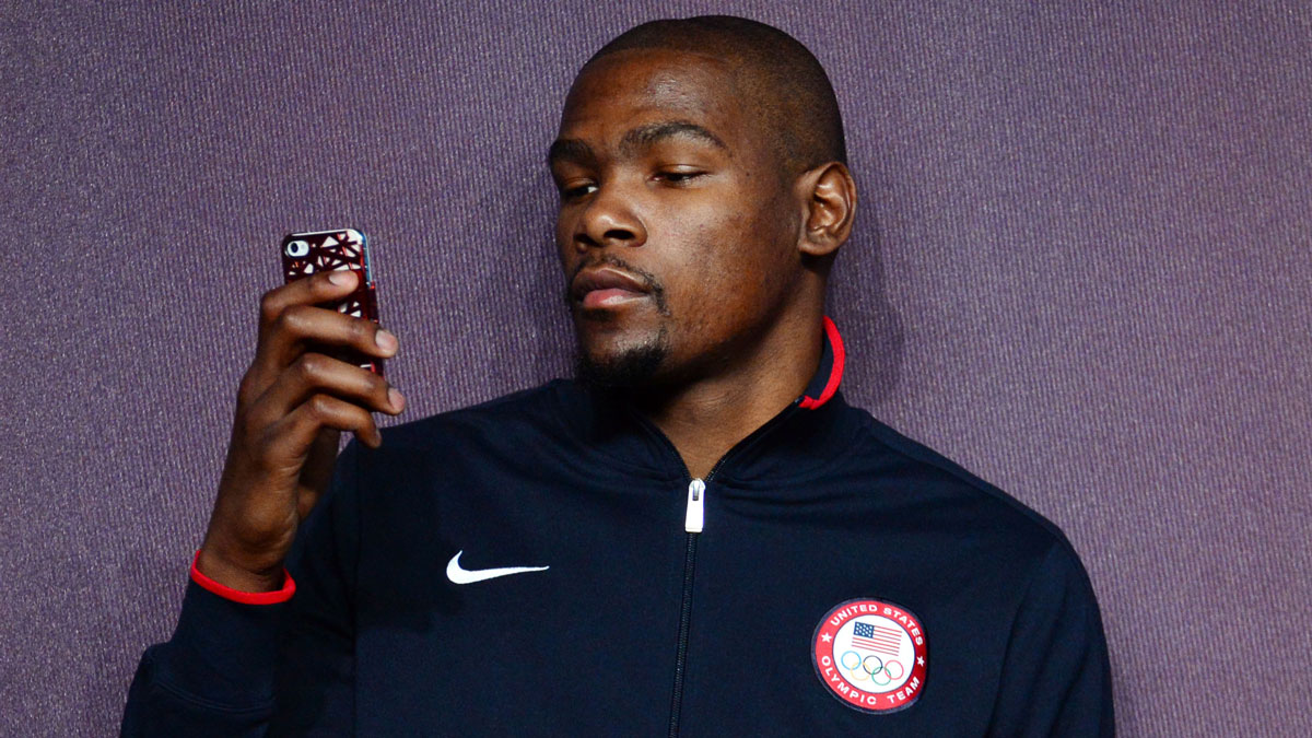 The United States goalkeeper Kevin during (5) checks his phone at a press conference in preparation for the 2012 London Olympic Games at the main press center.