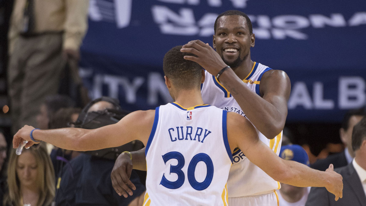 Golden State Warriors forward Kevin Durant (35, right) hugs guard Stephen Curry (30) after the game against the Toronto Raptors at Oracle Arena. The Warriors defeated the Raptors 121-111.