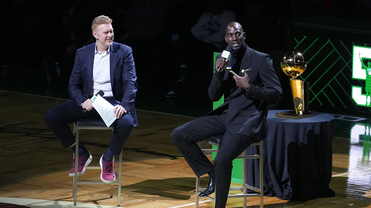 Basketball Hall of Fame and former Boston Celtic, Kevin Garnett speaks with Brian Scalabrine during the number retirement ceremony after the game between the Boston Celtics the Dallas Mavericks at TD Garden.