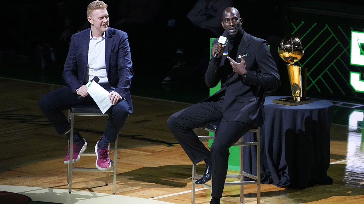 Basketball Hall of Fame and former Boston Celtic, Kevin Garnett speaks with Brian Scalabrine during the number retirement ceremony after the game between the Boston Celtics the Dallas Mavericks at TD Garden.