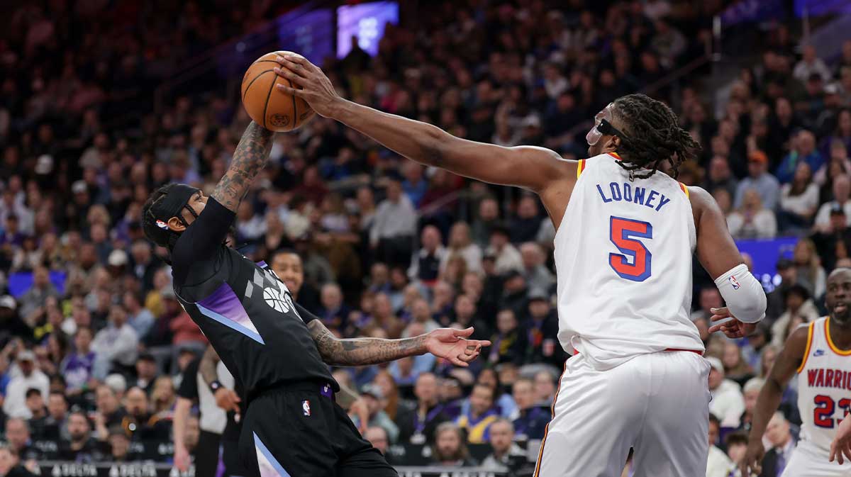 Golden State Warriors forward Kevon Looney (5now a pelicans player) blocks the shot of Utah Jazz guard Jordan Clarkson (00) during the second quarter at Delta Center.