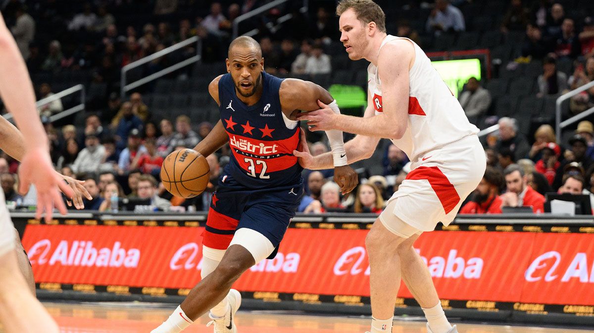 Washington Wizards forward Khris Middleton (32) drives to the basket against Toronto Raptors center Jakob Poeltl (19) during the second quarter at Capital One Arena.