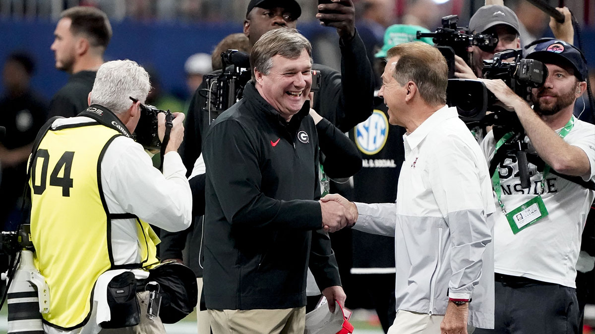 Georgia Bulldogs head coach Kirby Smart and Alabama Crimson Tide head coach Nick Saban meet before the SEC Championship Game at Mercedes-Benz Stadium.