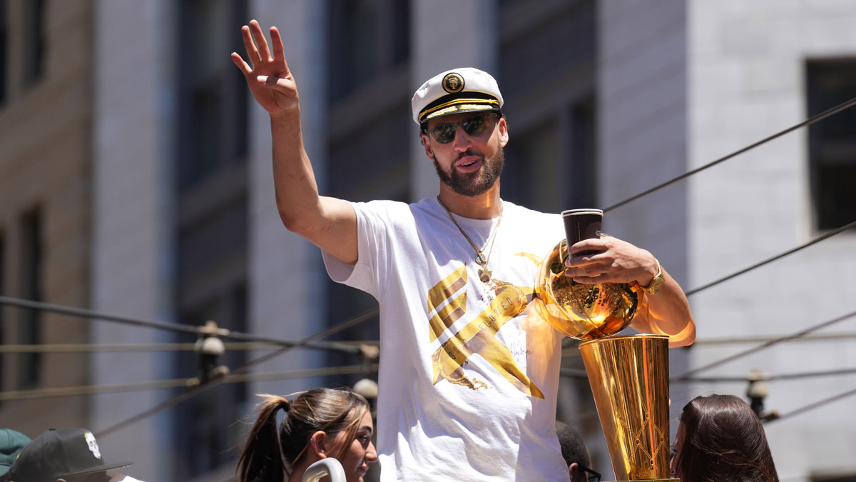 Golden State Warriors guard Klay Thompson gestures during the Golden State Warriors championship parade in downtown San Francisco.
