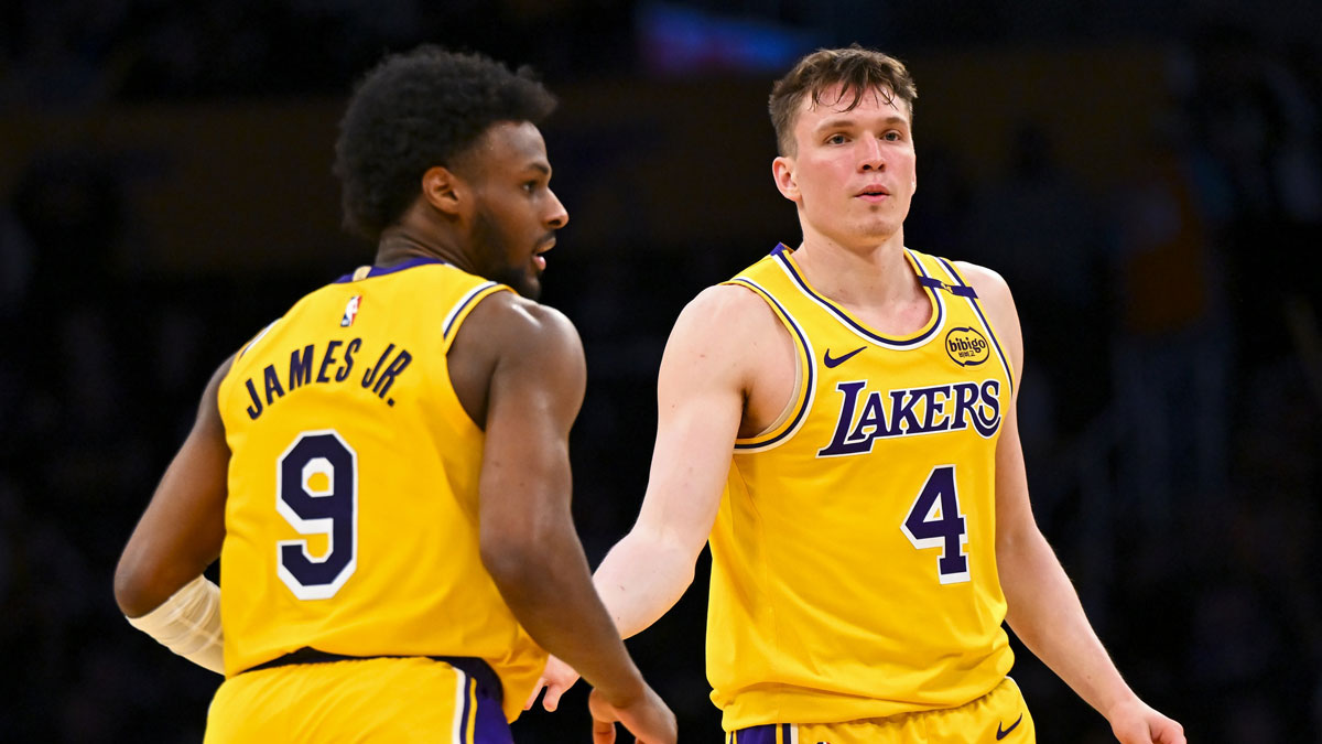Los Angeles Lakers guard Dalton Knecht (4) fives guard Bronny James (9) after scoring against the Milwaukee Bucks during the second half at Crypto.com Arena.