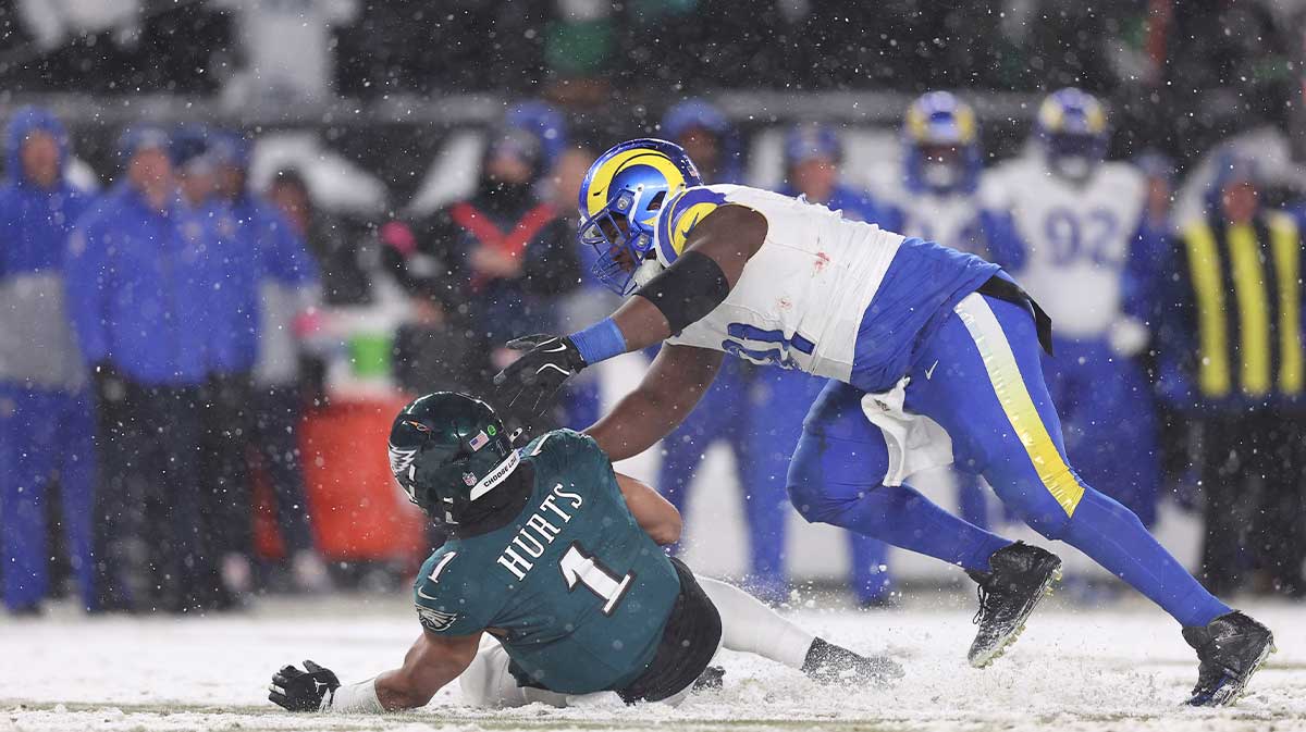 Philadelphia Eagles quarterback Jalen Hurts (1) is sacked by Los Angeles Rams defensive tackle Kobie Turner (91) in the second half in a 2025 NFC divisional round game at Lincoln Financial Field.