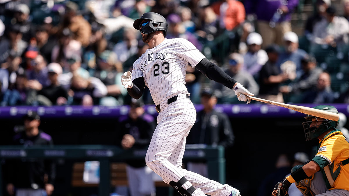 Colorado Rockies designated hitter Kris Bryant (23) hits a double in the third inning against the Athletics at Coors Field. Mandatory Credit: Isaia