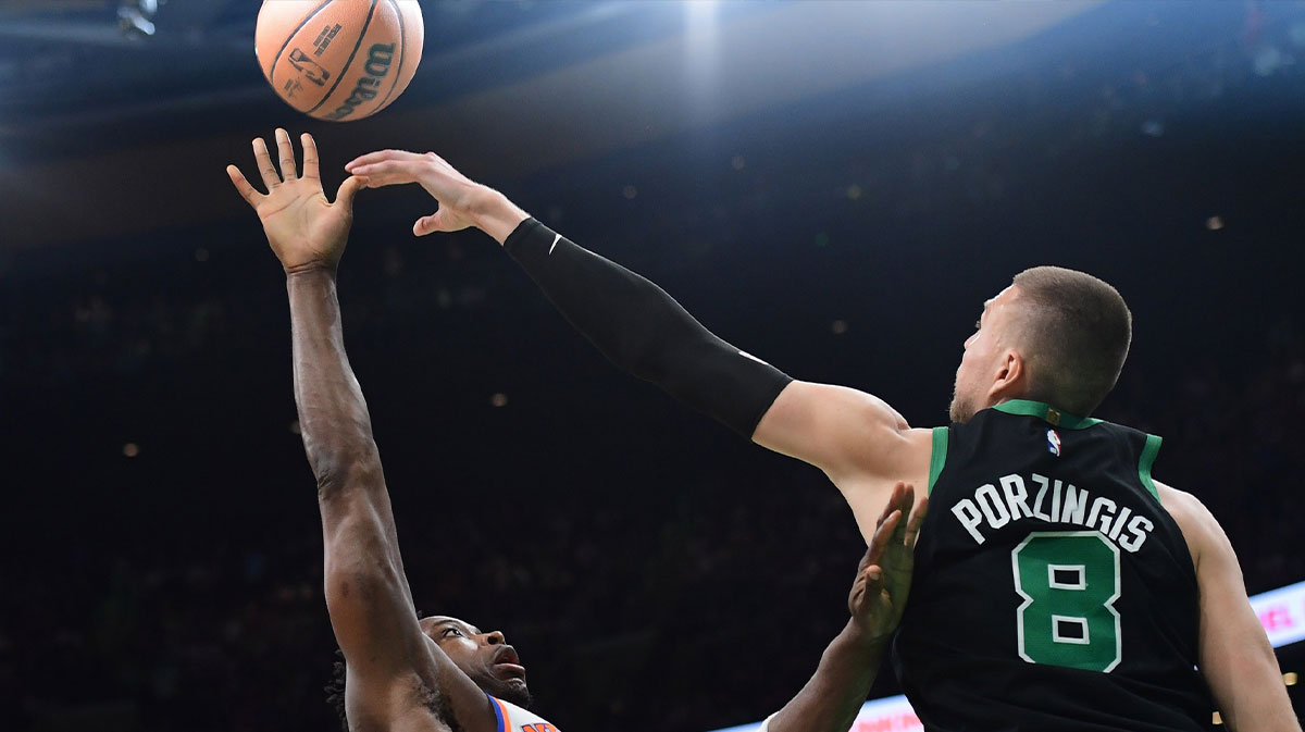 New York Knicks forward OG Anunoby (8) shoots the ball over Boston Celtics center Kristaps Porzingis (8 now a Hawks player) in the first half during game five of the second round for the 2025 NBA Playoffs at TD Garden.