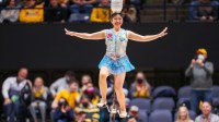 Acrobat and performer Krystal Niu, known as Red Panda, performs at halftime at WVU Coliseum.