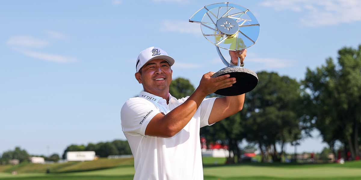 Kurt Kitayama celebrates with the trophy after winning the 3M Open golf tournament.