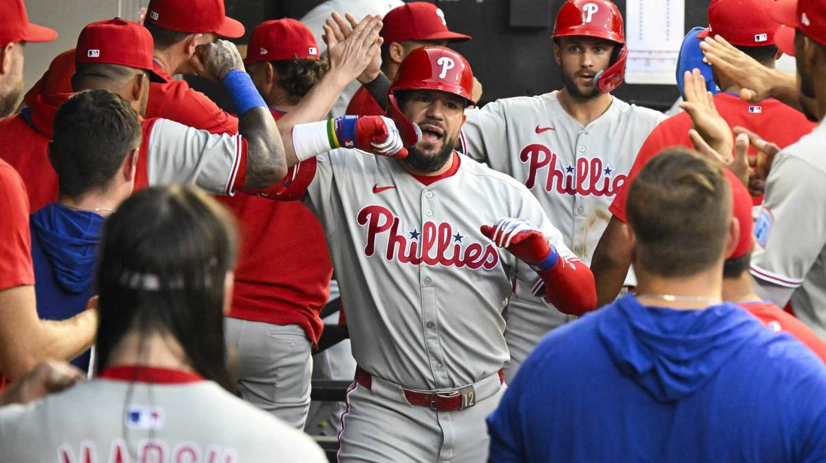 Philadelphia Phillies outfielder Kyle Schwarber (12) celebrates in the dugout after hitting a two-run home run during the third inning against the Chicago White Sox at Rate Field.