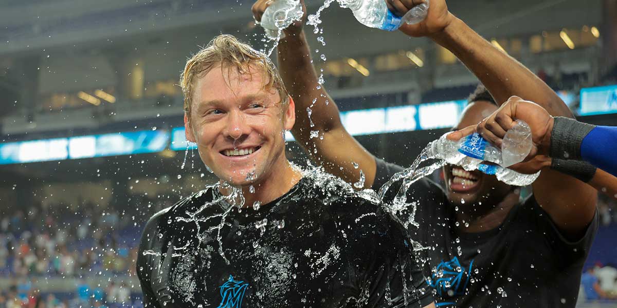 Jul 18, 2025; Miami, Florida, USA; Miami Marlins left fielder Kyle Stowers (28) is doused with water by teammates after hitting a two-run walk-off home run against the Kansas City Royals during the tenth inning at loanDepot Park. 