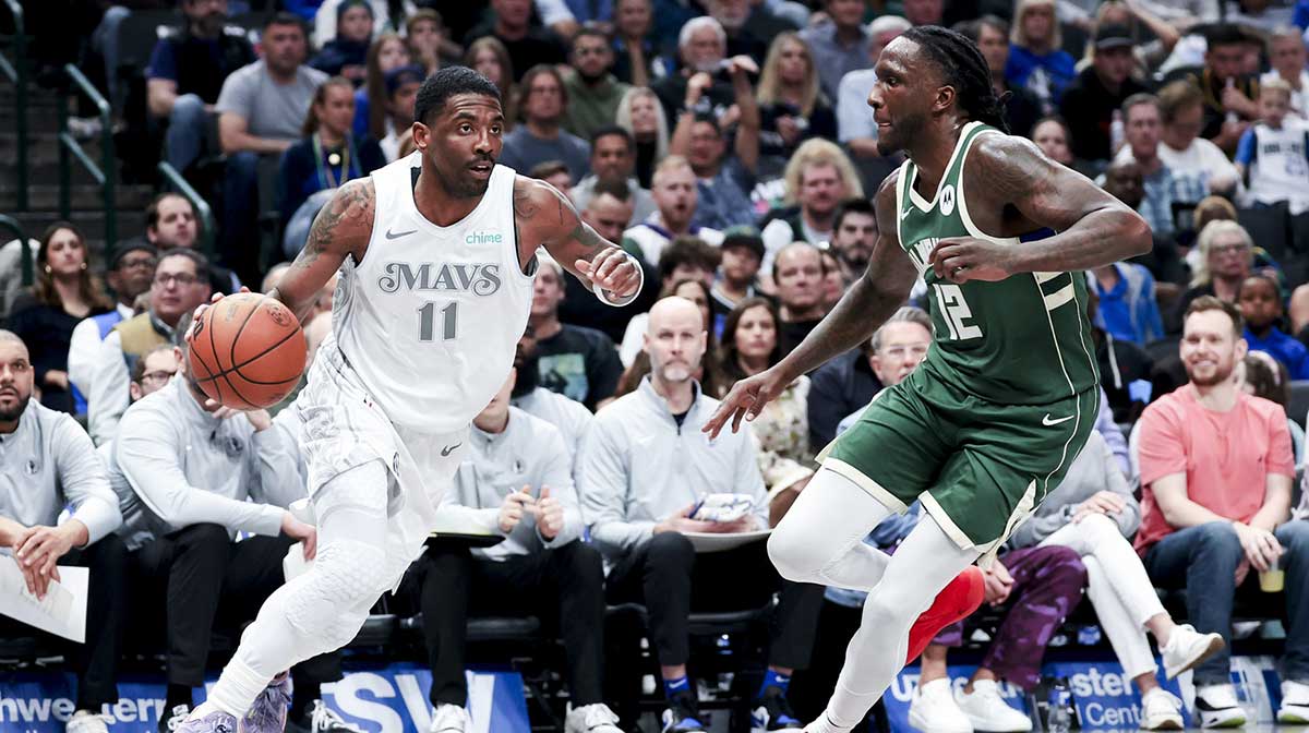 Dallas Mavericks guard Kyrie Irving (11) dribbles as Milwaukee Bucks forward Taurean Prince (12) defends during the first half at American Airlines Center.