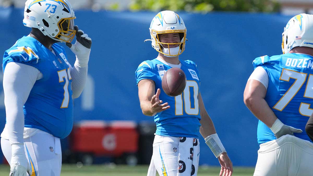 Los Angeles Chargers quarterback Justin Herbert (10) talks with guard Mekhi Becton (73) and center Bradley Bozeman (75) during training camp at The Bolt.