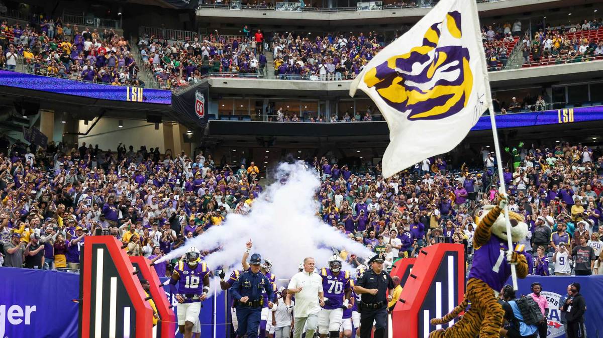 LSU Tigers head coach Brian Kelly and the LSU tigers run out on the field before playing against the Baylor Bears at NRG Stadium.