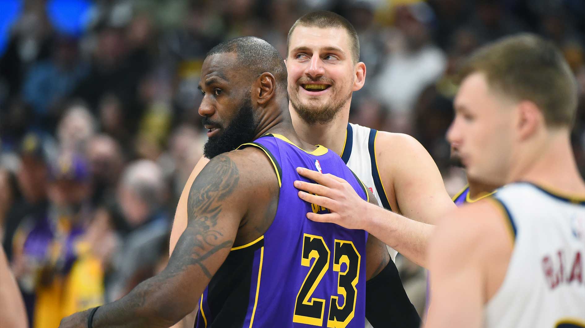 Nuggets center Nikola Jokic (15) and Los Angeles Lakers forward LeBron James (23) hug before the game at Ball Arena