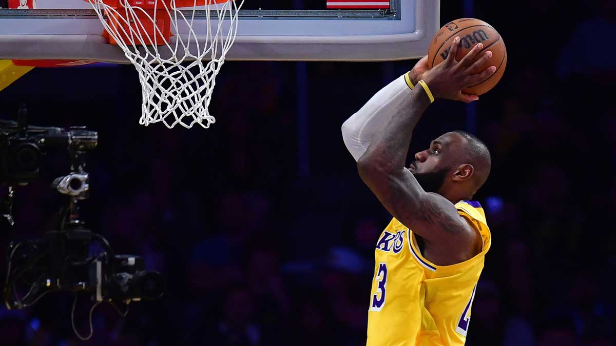 Lakers forward LeBron James (23) moves in for the dunk against the Minnesota Timberwolves during the second half in game five of first round for the 2025 NBA Playoffs at Crypto.com Arena with ESPN's Brian Windhorst in the background