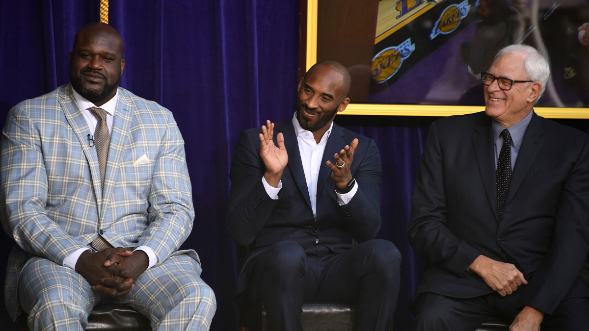 Lakers' Shaquille O'Neal (left), Kobe Bryant (center) and Phil Jackson react during ceremony to unveil statue of former Los Angeles Lakers center O'Neal at Staples Center