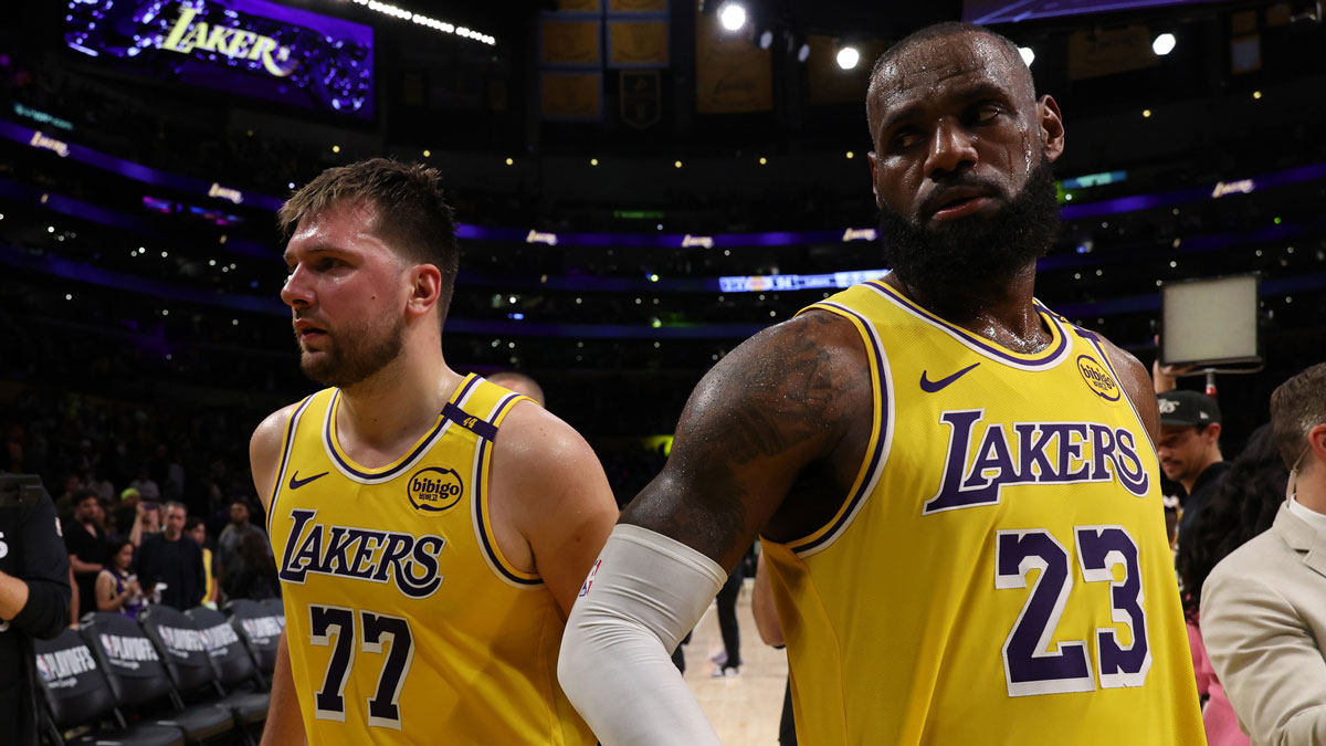 Lakers guard Luka Doncic (77) and Los Angeles Lakers forward LeBron James (23) leave a court after defeating the Minnesota Timberwolves 94-85 in game two of first round for the 2024 NBA Playoffs at Crypto.com Arena with NBA analyst Charles Barkley in the background