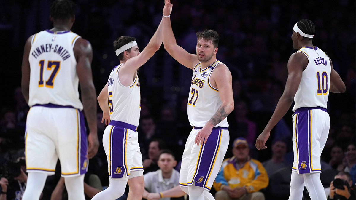 Los Angeles Lakers guard Luka Doncic (77) and guard Austin Reaves (15) celebrate against the Phoenix Suns in the second half at Crypto.com Arena.