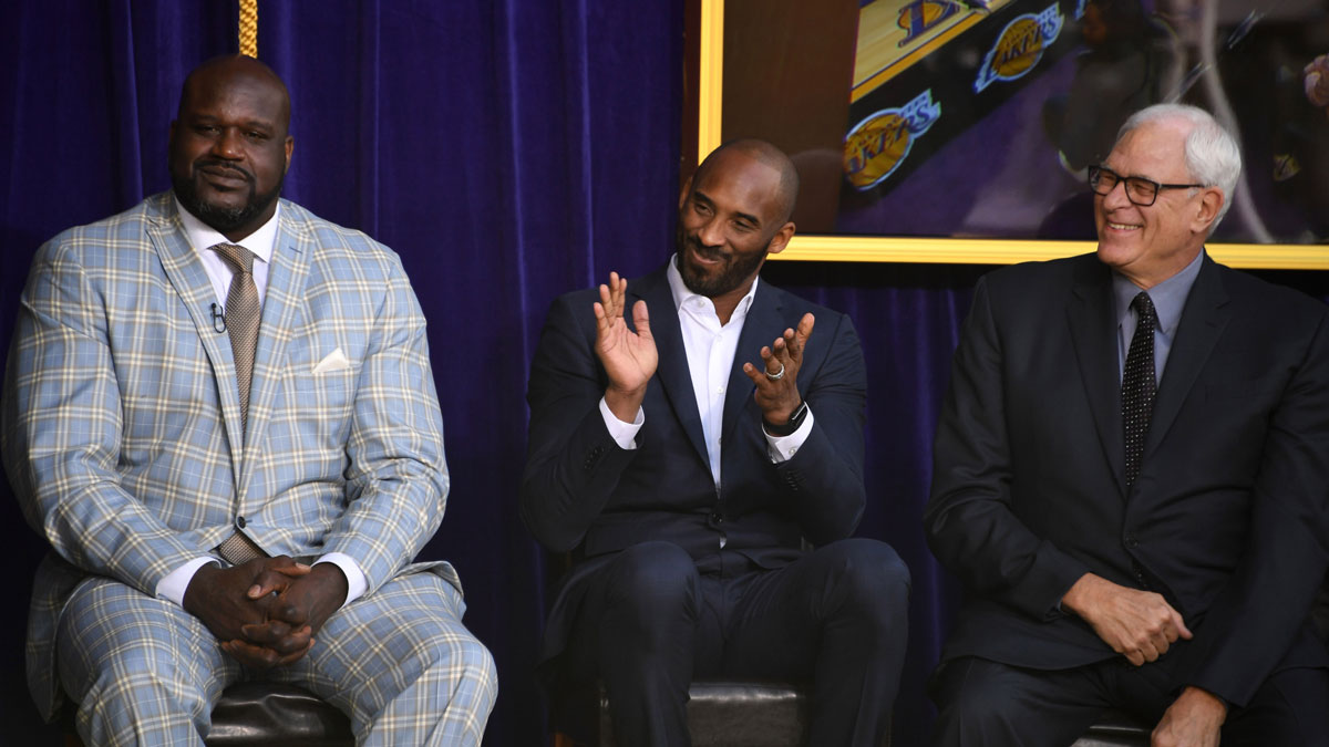 Lakers Shaquille O'Neal (left), Kobe Bryant (center) and Phil Jackson react during ceremony to unveil statue of former Los Angeles Lakers center O'Neal at Staples Center