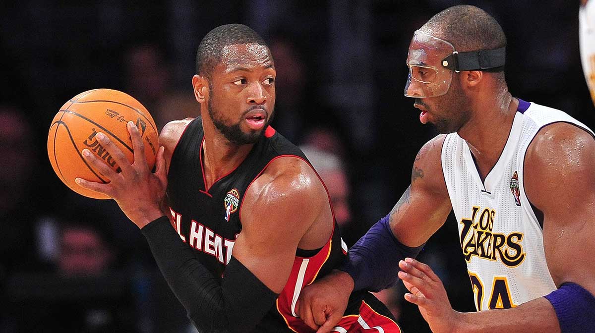 Heat shooting guard Dwyane Wade (3) controls the ball against the defense of Los Angeles Lakers shooting guard Kobe Bryant (24) during the second half at Staples Center