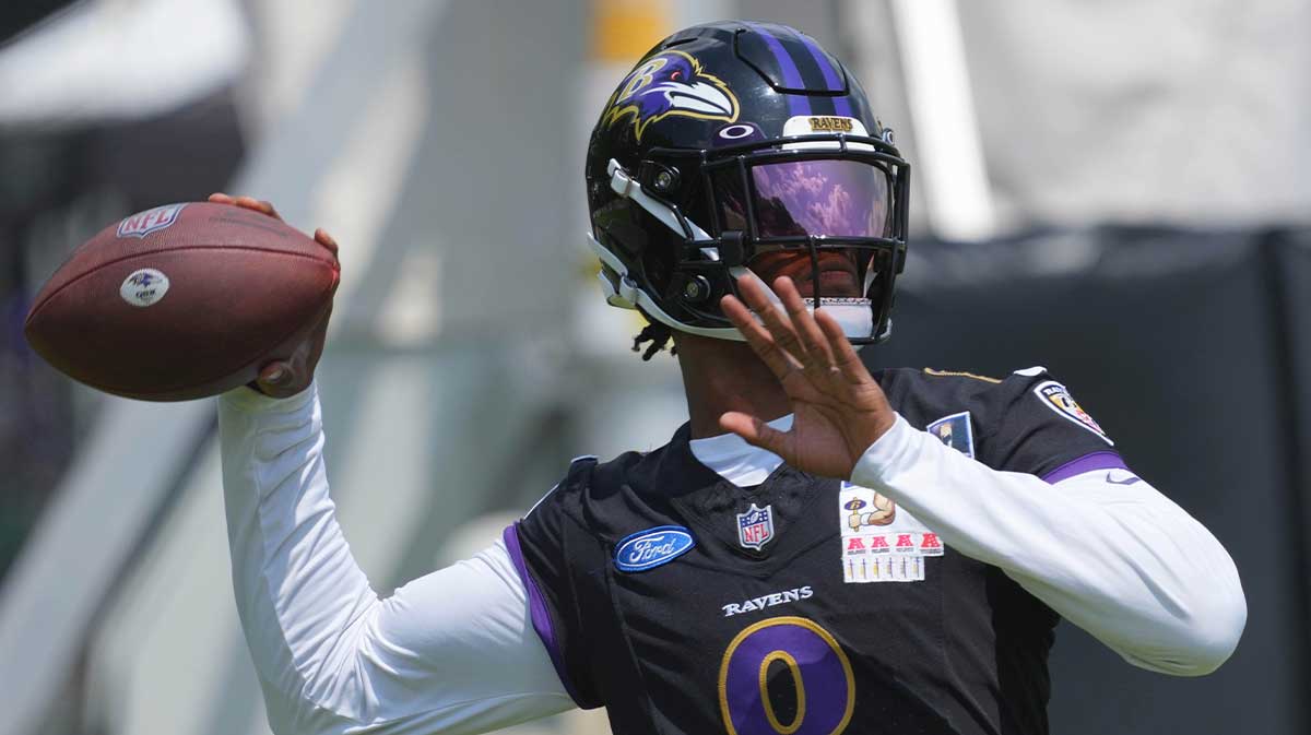 Baltimore Ravens quarterback Lamar Jackson (8) warms up during training camp at Under Armour Performance Center.