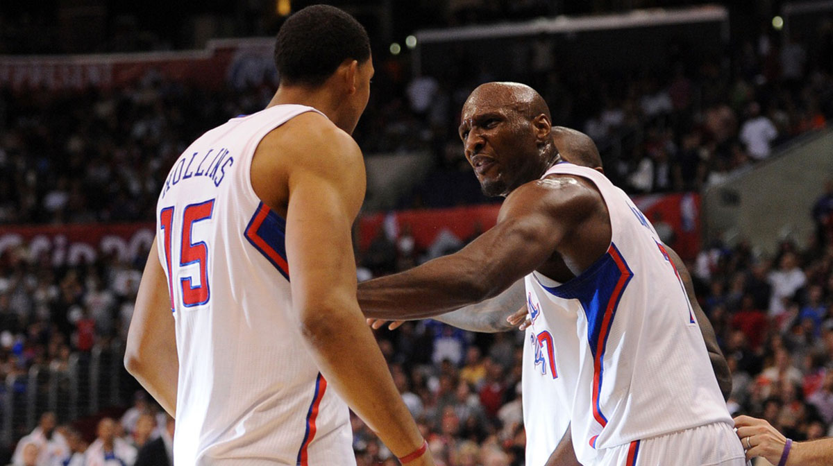 Los Angeles Clippers center Ryan Hollins (15) is held back by Los Angeles Clippers forward Lamar Odom (7) after a fight with Phoenix Suns forward Michael Beasley (not pictured) during the fourth period at the Staples Center. The Los Angeles Clippers defeated the Phoenix Suns 126-101.