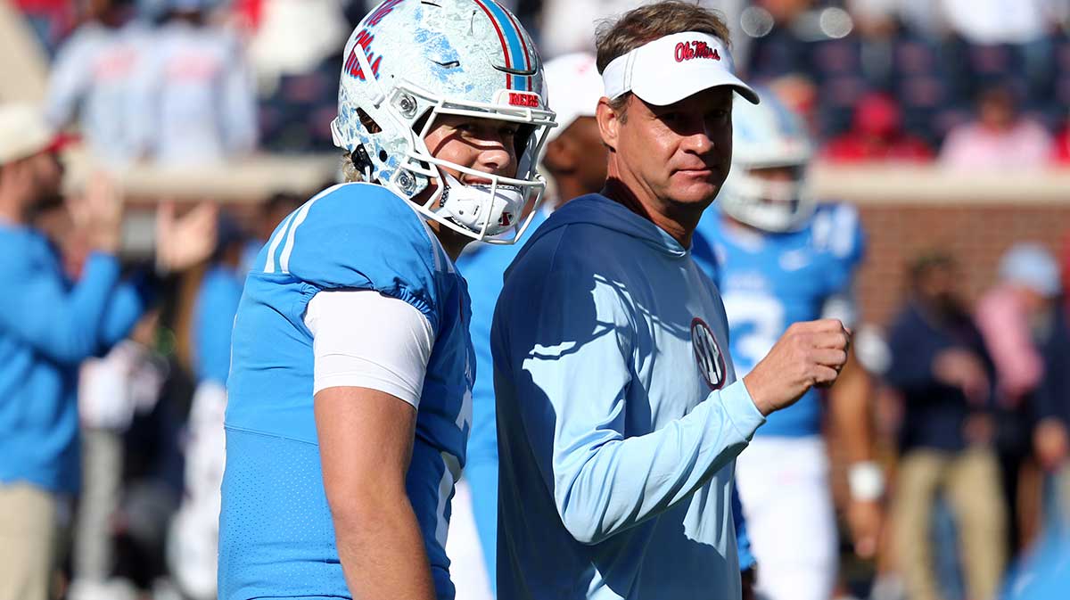 Mississippi Rebels quarterback Jaxson Dart (2) and head coach Lane Kiffin (right) talk during warm ups prior to the game against the Texas A&M Aggies at Vaught-Hemingway Stadium.